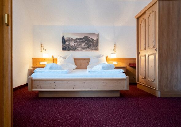The double bed in the Auhof Suite at Hotel Das Hintersee in Salzkammergut in Austria