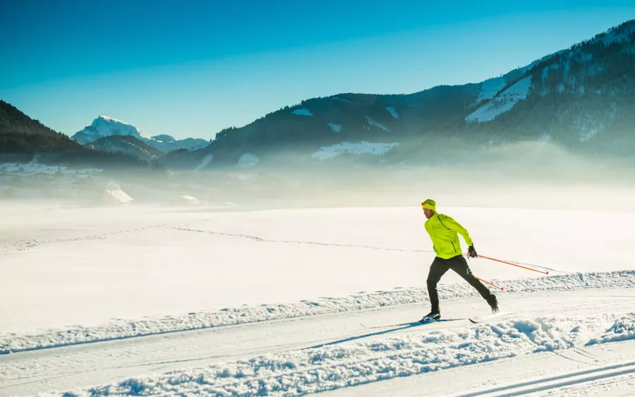 A cross-country skier travels on a beautifully groomed trail