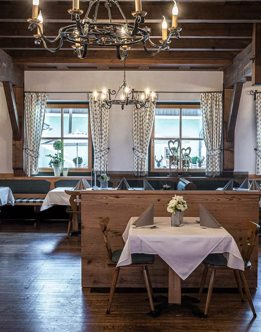 The dining room at the Gasthof DAS Hintersee with tables set