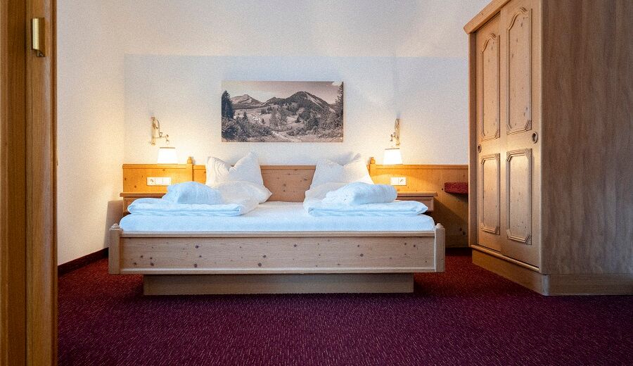 The double bed in the Auhof Suite at Hotel Das Hintersee in Salzkammergut in Austria