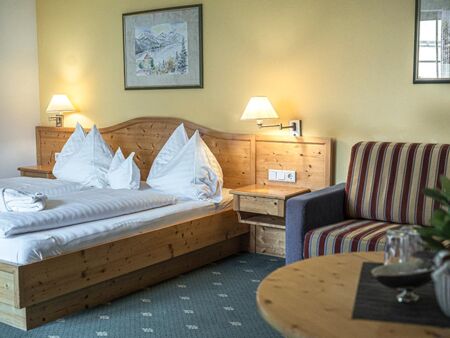 The modern wooden furnishings of the Sonnberg Double Room Classic with comfortable couch