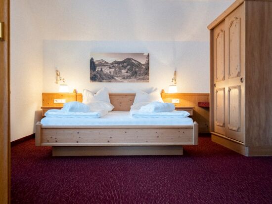 The double bed in the Auhof Suite at Hotel Das Hintersee in Salzkammergut in Austria