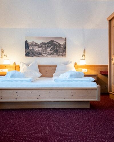 The double bed in the Auhof Suite at Hotel Das Hintersee in Salzkammergut in Austria