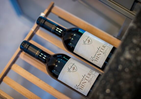 Two bottles of wine on a shelf