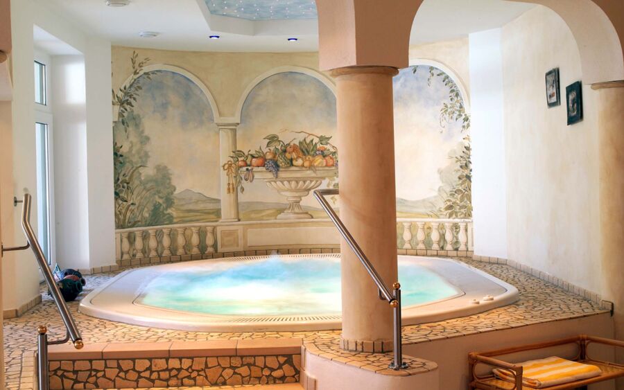 The hotel's spacious whirlpool features Roman-style murals