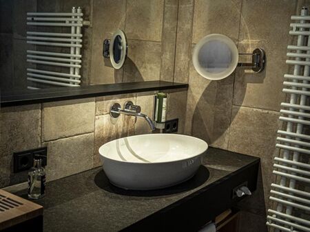The newly renovated bathrooms at DAS Hintersee are dark and elegant.