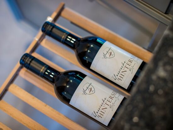 Two bottles of wine on a shelf