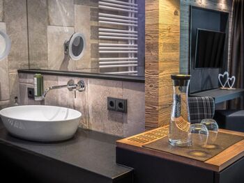 Modern in natural stone tile covered with stylish wood accents