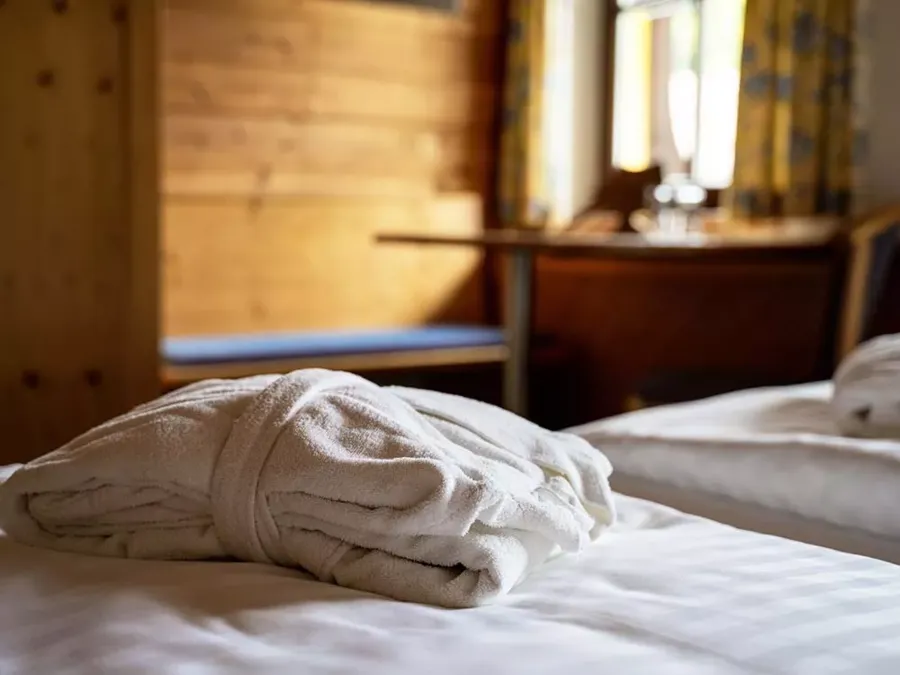 Bathrobe on the bed in the room at the Hotel Hintersee in Austria