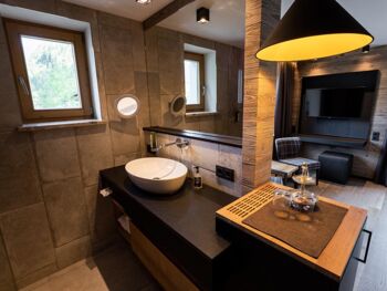 Light-flooded hotel room with huge flat-screen TV