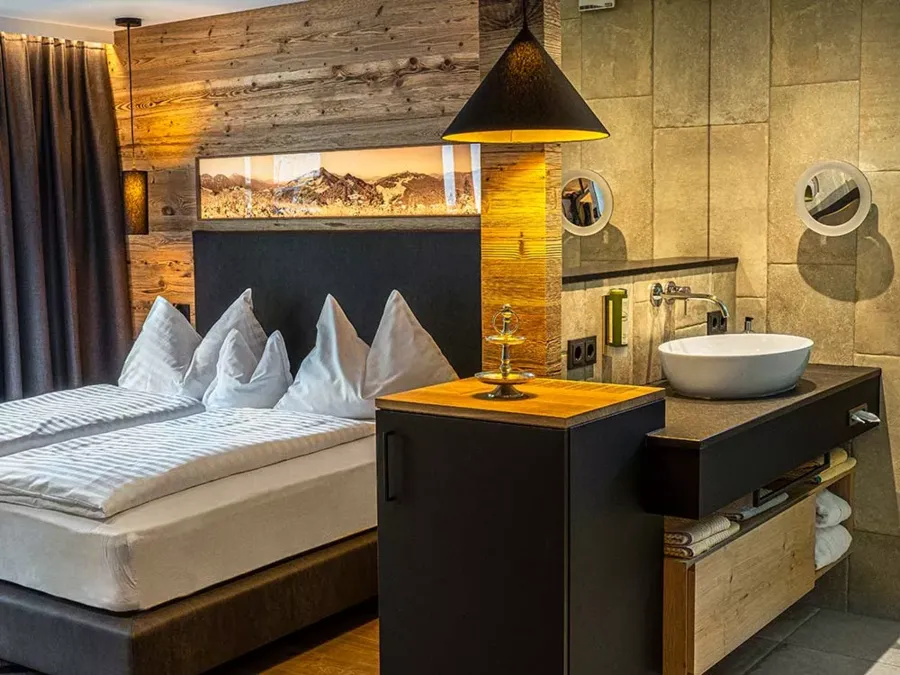 The cosy double bed and part of the bathroom in the Anzenberg apartment