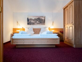 The double bed in the Auhof Suite at Hotel Das Hintersee in Salzkammergut in Austria