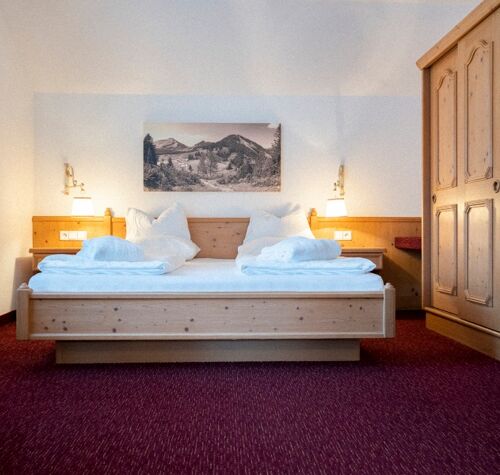 The double bed in the Auhof Suite at Hotel Das Hintersee in Salzkammergut in Austria