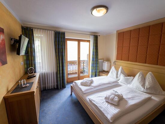 The homely furnishings of the sleeping area with access to the balcony