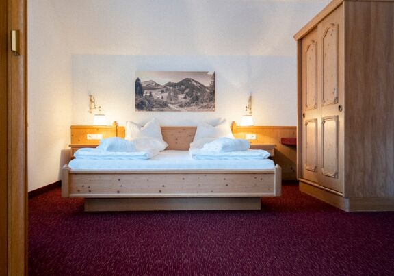 The double bed in the Auhof Suite at Hotel Das Hintersee in Salzkammergut in Austria