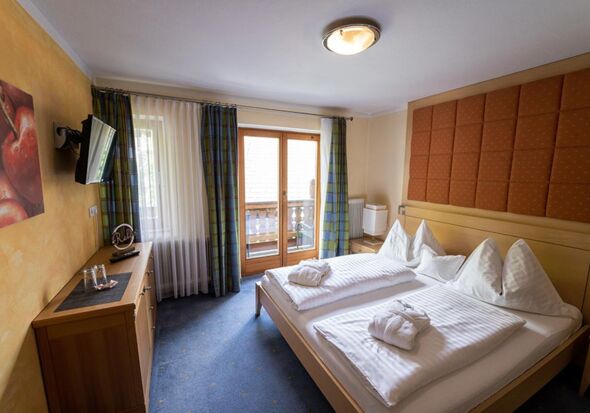 The homely furnishings of the sleeping area with access to the balcony