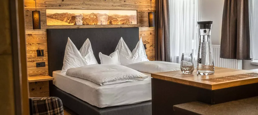 Large box-spring bed for a relaxing night at Hotel Hintersee