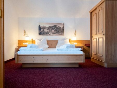 The double bed in the Auhof Suite at Hotel Das Hintersee in Salzkammergut in Austria