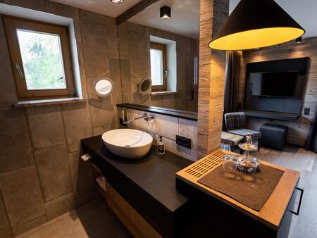 Light-flooded hotel room with huge flat-screen TV