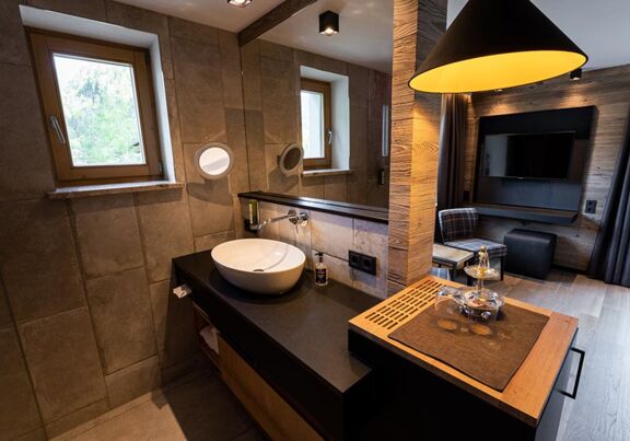 Light-flooded hotel room with huge flat-screen TV