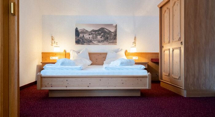 The double bed in the Auhof Suite at Hotel Das Hintersee in Salzkammergut in Austria