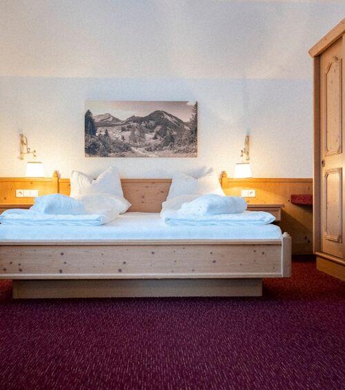 The double bed in the Auhof Suite at Hotel Das Hintersee in Salzkammergut in Austria