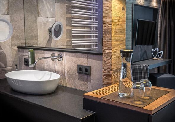 Modern in natural stone tile covered with stylish wood accents
